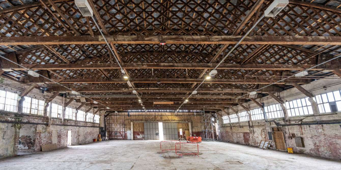 Panoromic interior image after strip out showing retained walls and Belfast trusses of the Hangar 16U at Filton, Bristol